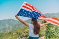 Girl in medical mask holding an American flag in her hands. Celebrate the fourth of July during pandemic Royalty Free Stock Photo