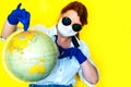 Girl in medical mask and sunglasses  is looking for a place on the map Royalty Free Stock Photo