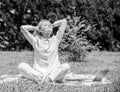 Girl meditate on rug green grass meadow nature background. Woman relaxing practicing meditation. Every day meditation Royalty Free Stock Photo