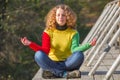 Girl meditates on the bridge