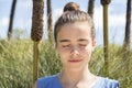 Girl meditates in front of a reed field