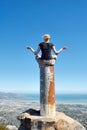 Girl meditates on top of column in mountains Royalty Free Stock Photo