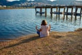 Girl meditating by the lake during the golden hour