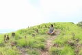 Girl meditating among stone stacks on Padar Island