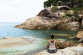 The girl meditating on stones by the sea, the Girl borrowing with yoga the island Samui, yoga in Thailand.
