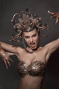 Girl Medusa headdress of gold color on a black background Royalty Free Stock Photo