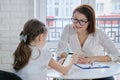 Girl at meeting with psychologist showing his social page on smartphone