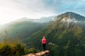 Girl meets sunrise in the mountains. Girl traveling to Sri Lanka. Mountain sports. Athlete happy finish. Mountain tourism