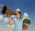 Girl with megaphone and small tree Royalty Free Stock Photo