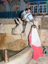 A girl - a member of the Knights of Jerusalem club, dressed in the traditional costume of a medieval lady, submits a sword to a kn