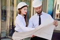 A girl with a man in construction white helmets and white shirts Royalty Free Stock Photo