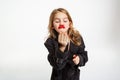 Girl with messy make up air kissing, hoding red lipstick. Royalty Free Stock Photo