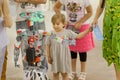 Girl met with a mechanical robot at the exhibition of young technician designers