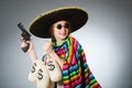 Girl in mexican poncho holding handgun and money Royalty Free Stock Photo