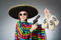 Girl in mexican poncho holding handgun and money Royalty Free Stock Photo