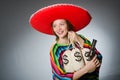 Girl in mexican poncho holding handgun and money Royalty Free Stock Photo