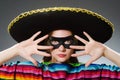 The girl in mexican vivid poncho against gray Royalty Free Stock Photo