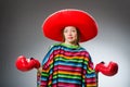 The girl in mexican vivid poncho and box gloves Royalty Free Stock Photo