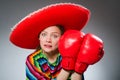 The girl in mexican vivid poncho and box gloves Royalty Free Stock Photo