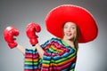 The girl in mexican vivid poncho and box gloves Royalty Free Stock Photo