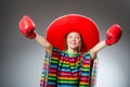 The girl in mexican vivid poncho and box gloves Royalty Free Stock Photo