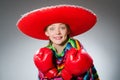 The girl in mexican vivid poncho and box gloves Royalty Free Stock Photo