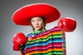 Girl in mexican vivid poncho and box gloves Royalty Free Stock Photo