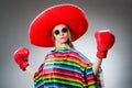 Girl in mexican vivid poncho and box gloves Royalty Free Stock Photo