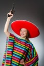 The girl in mexican vivid poncho holding handgun Royalty Free Stock Photo