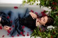 Girl milk water bath red rose leave ivy Royalty Free Stock Photo