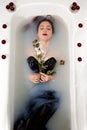 Girl milk water bath red roses candles Royalty Free Stock Photo