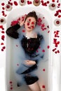 Girl milk water bath red roses candles Royalty Free Stock Photo