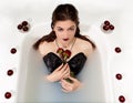 Girl milk water bath red roses candles Royalty Free Stock Photo