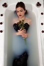 Girl milk water bath red roses candles Royalty Free Stock Photo