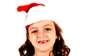 Girl missing her two front teeth wearing santa hat