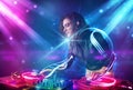 Girl mixing music with powerful light effects Royalty Free Stock Photo
