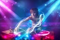 Girl mixing music with powerful light effects Royalty Free Stock Photo