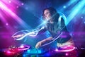 Girl mixing music with powerful light effects