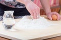 Girl is mixing the water and flour Royalty Free Stock Photo