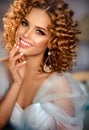 Girl model with dense, curly hair, dressed in evening gown. Royalty Free Stock Photo