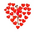 Girl model in a heart made of balloons. Beautiful woman with the symbol of Valentine`s Day. Red Valentine on a white background Royalty Free Stock Photo