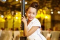 Girl-model stands, leaning decorative lamppost Royalty Free Stock Photo