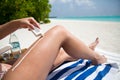 Girl moistures her legs with sun lotion Royalty Free Stock Photo