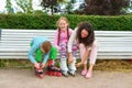 Girl with mom and brother wearing roller skates in the Park on t Royalty Free Stock Photo