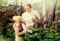 Girl with mom choosing New Year`s tree