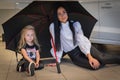 Girl and mom in exhibition hall for car