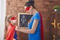 Girl and mom in Superhero costumes Royalty Free Stock Photo