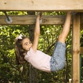 Girl on monkey bars.