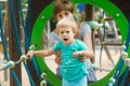 Girl with mother at action-oriented playground