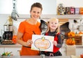 Girl with mother showing halloween Jack-O-Lantern drawing Royalty Free Stock Photo